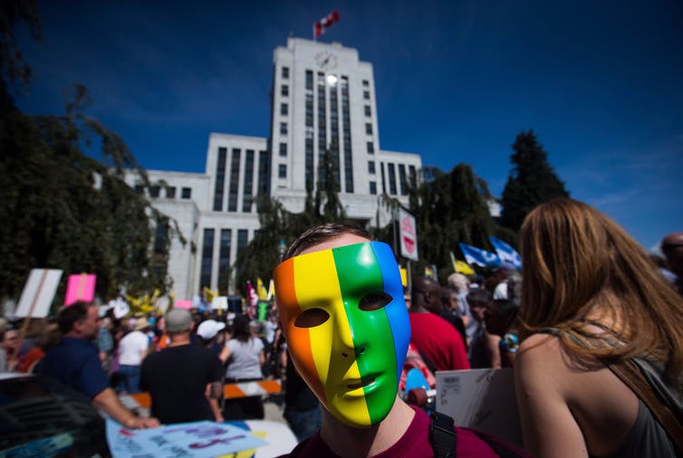 A man wearing a rainbow mask participates in an anti racist protest on Aug. 19 at Vancouver City Hall. Approximately 4000 protestors were there to demonstrate against a white extremist rally. 