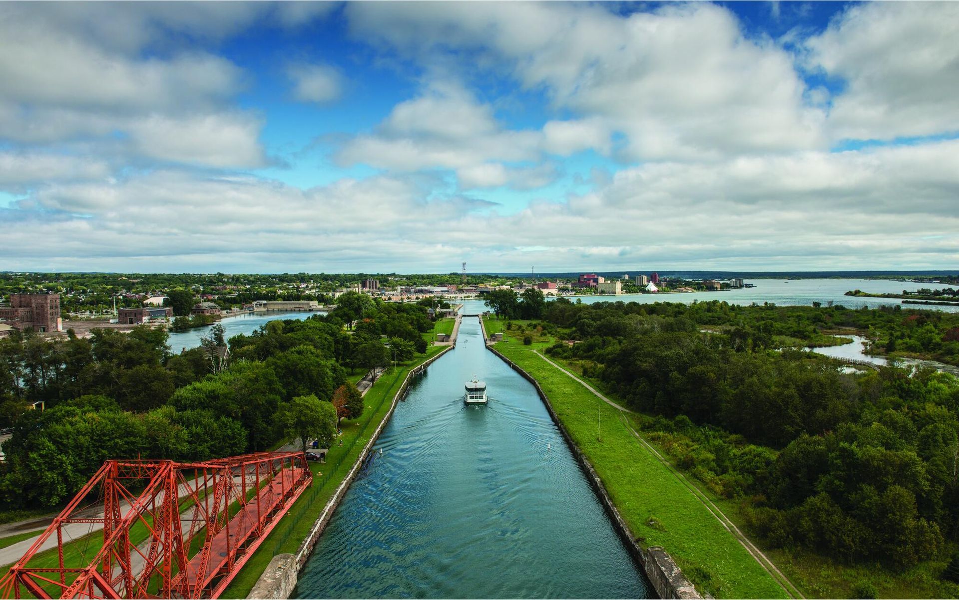 An aerial view of a boat going down a river.