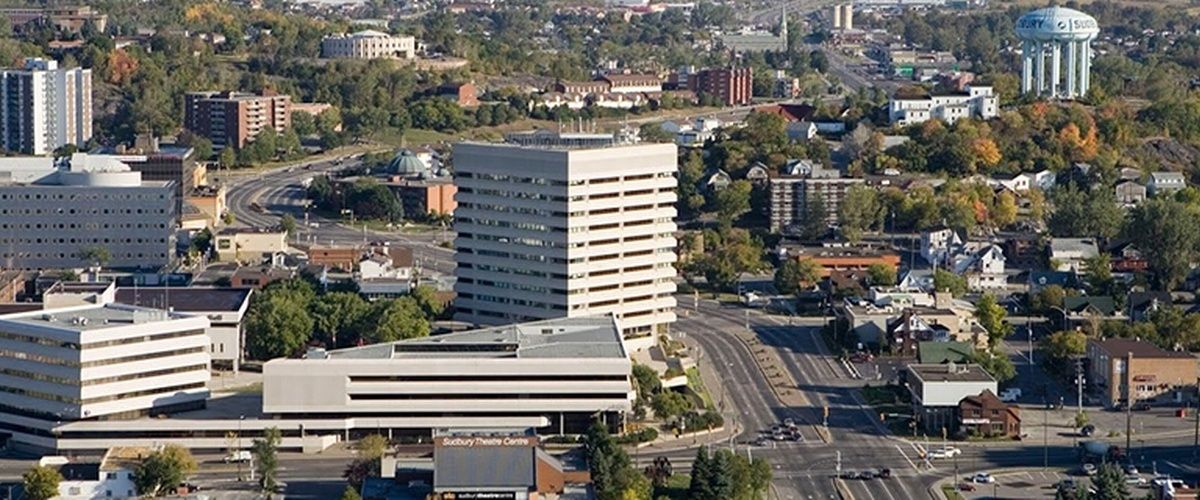 An aerial view of a city with lots of buildings and trees