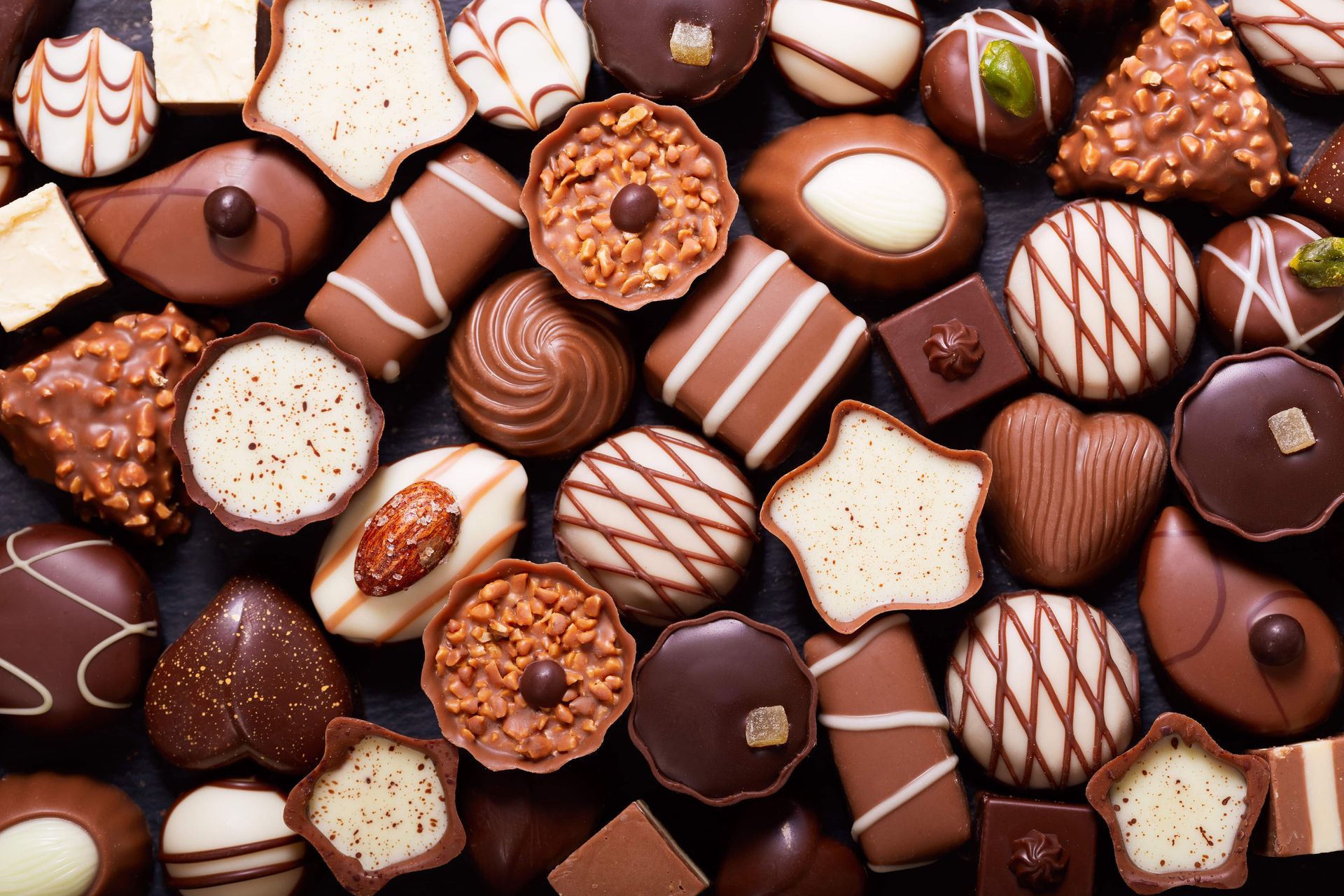 There are many different types of chocolates on the table.
