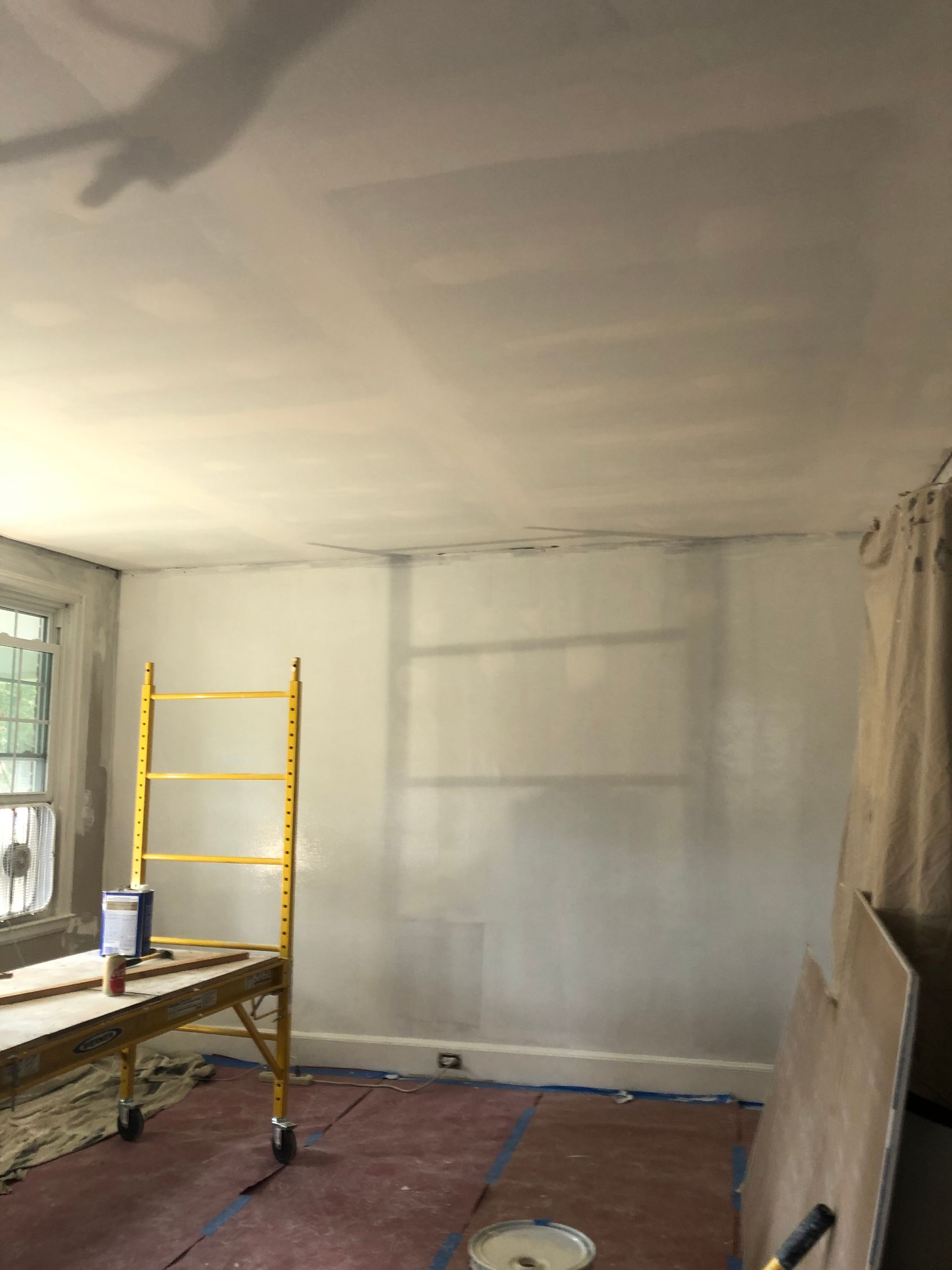 An empty room with drywall on the walls and ceiling