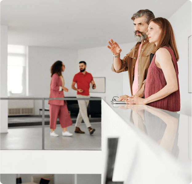 A man and a woman are standing next to each other in a room.