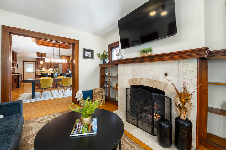 A living room with a fireplace and a flat screen tv.