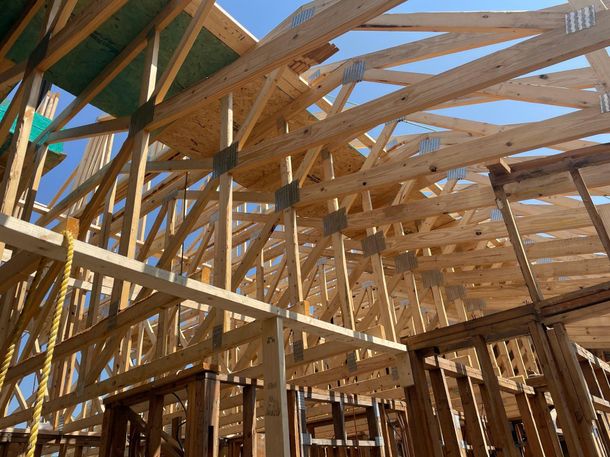 A house is being built with a lot of wooden beams