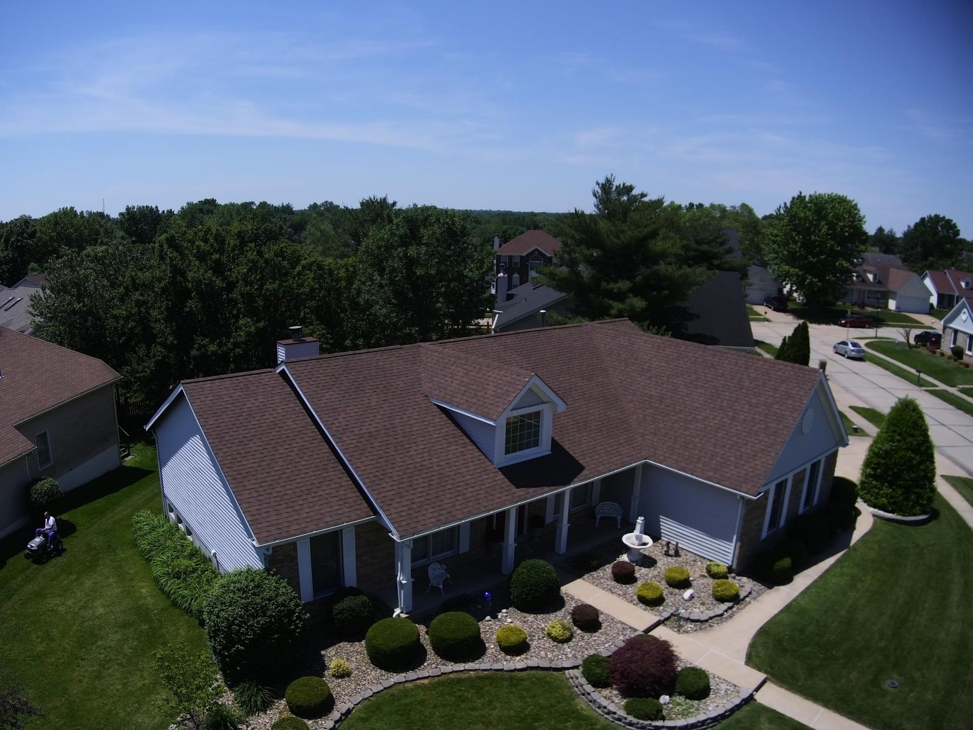 An aerial view of a house with a brown roof