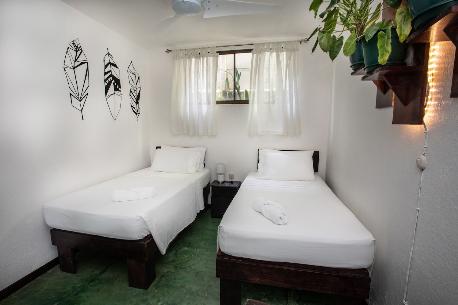 private room with two twin beds and a shared bathroom