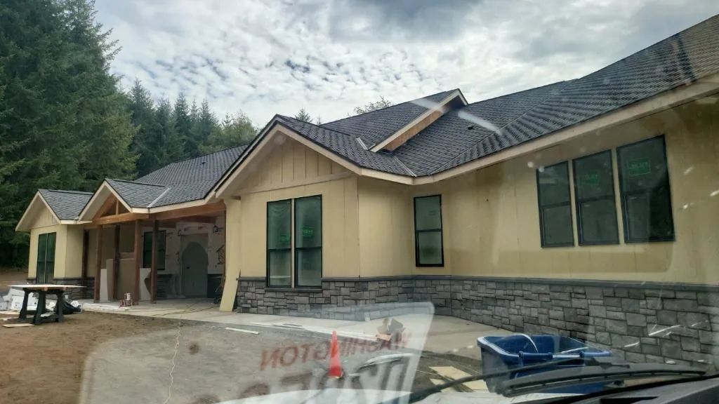 Professionally painted new construction home with completed exterior finish