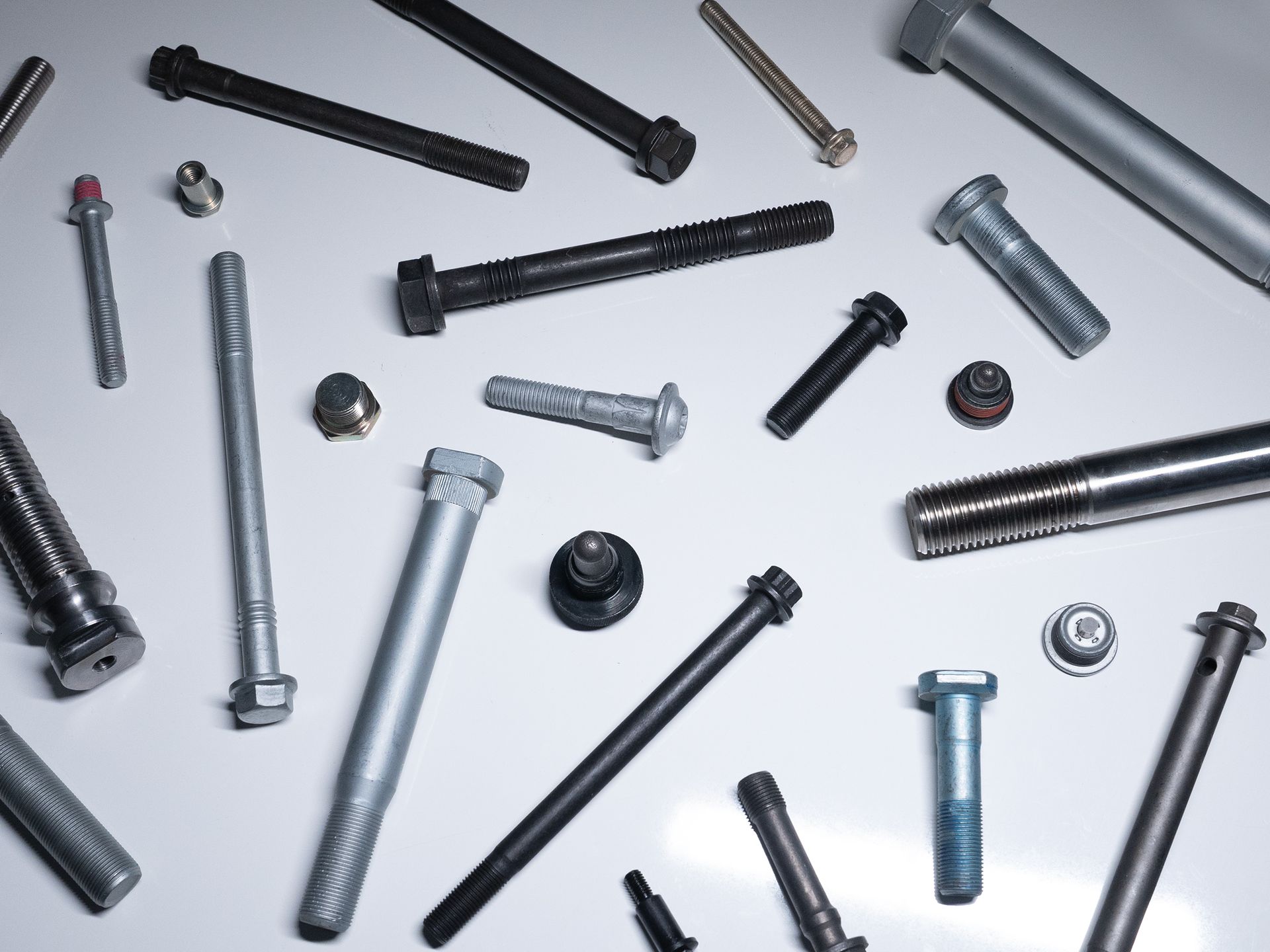 A collection of OEM stainless-steel fasteners, including bolts, nuts, and screws.