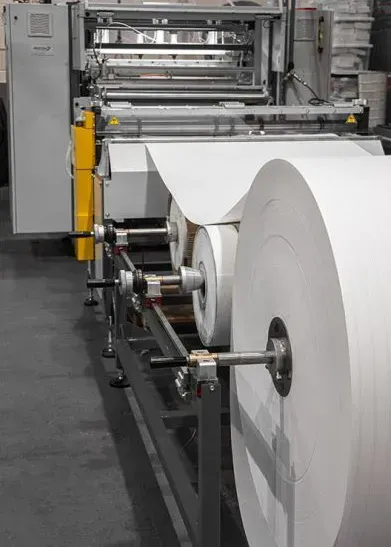 An advanced pleater machine for HVAC air filters in a manufacturing facility.