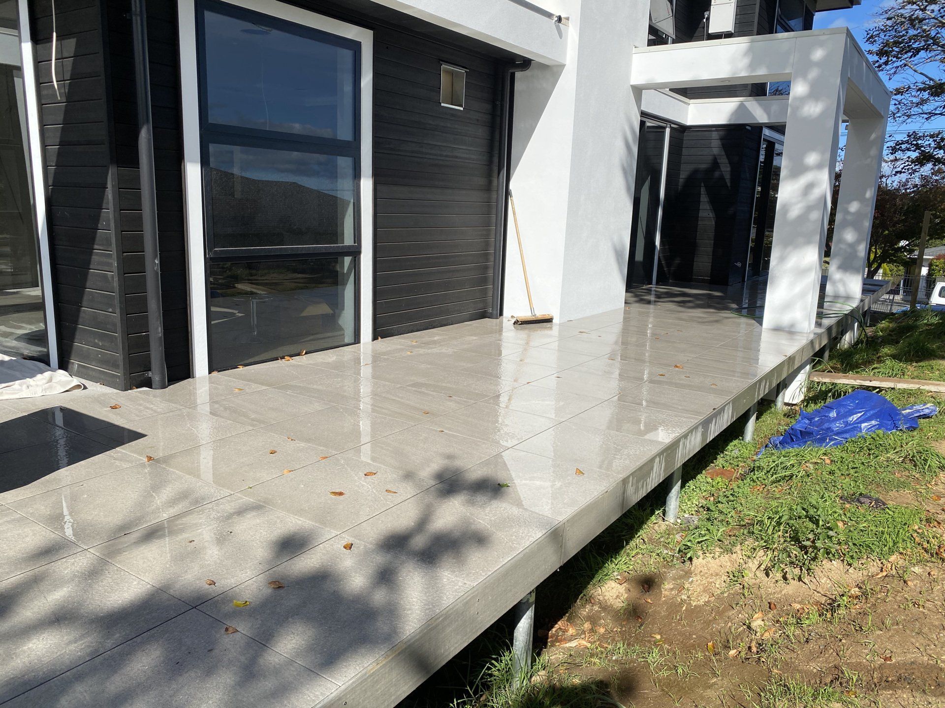 A concrete deck is sitting in front of a house.