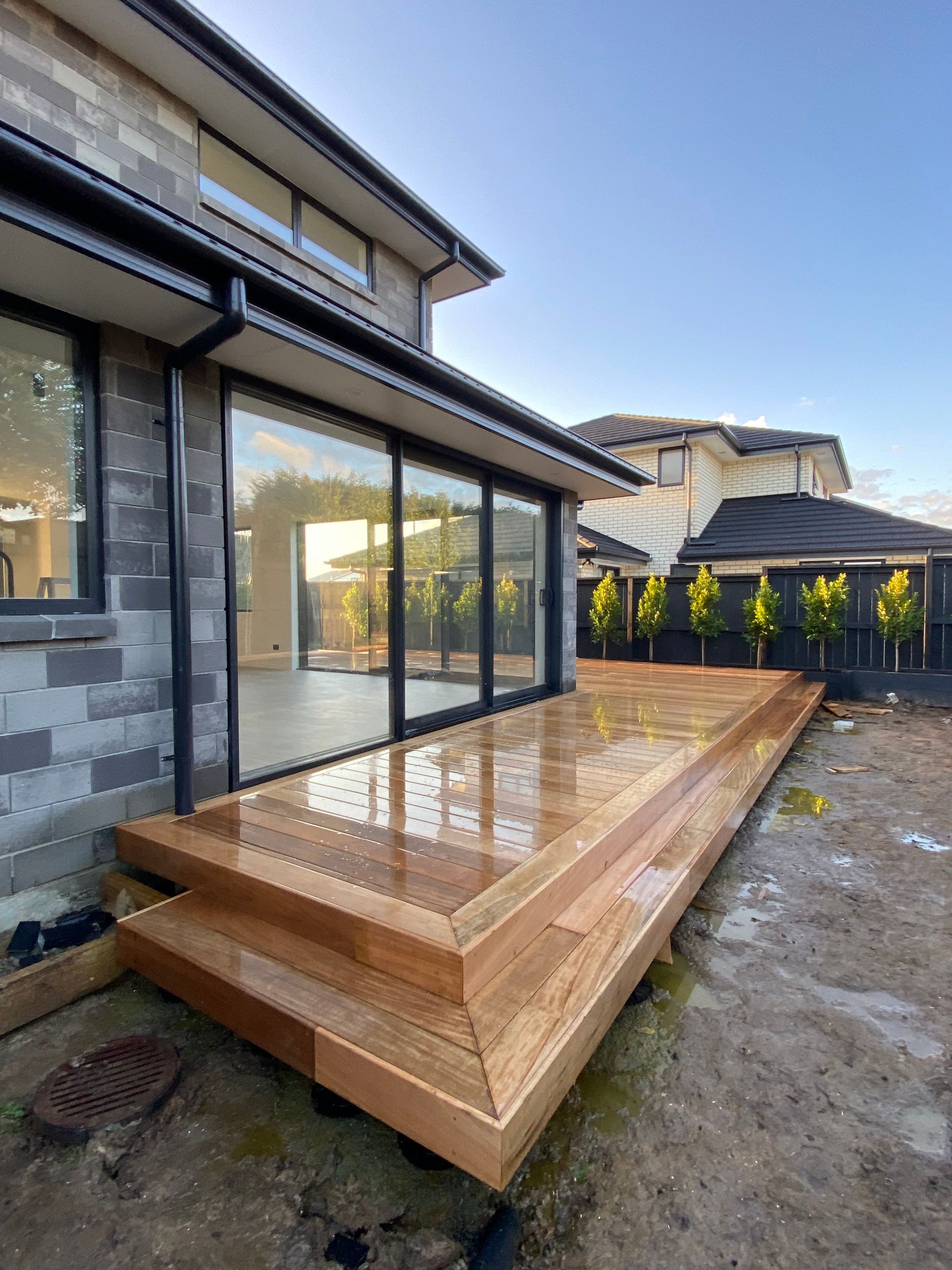 A large house with a wooden deck in front of it.