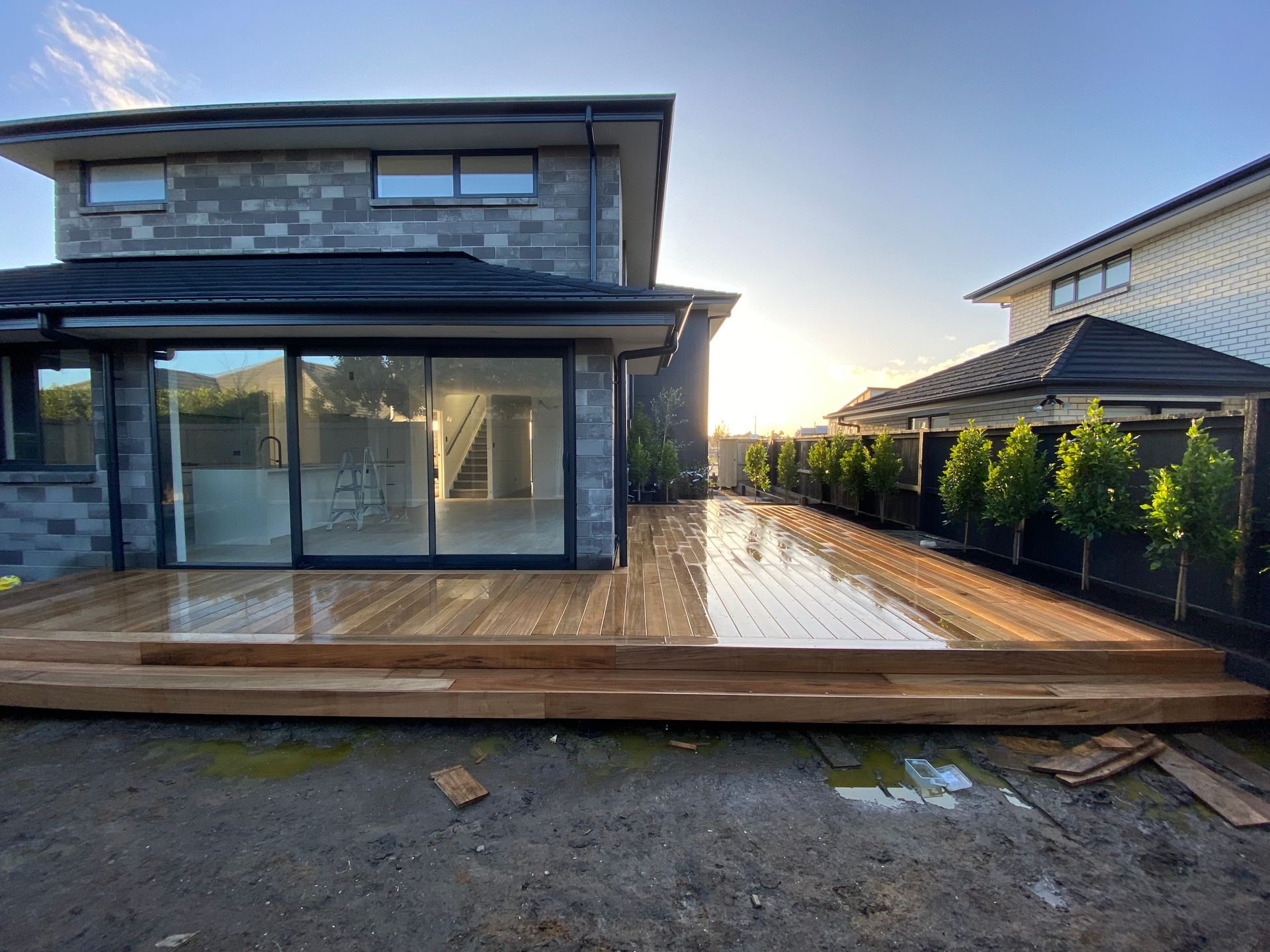 A house with a wooden deck in front of it.