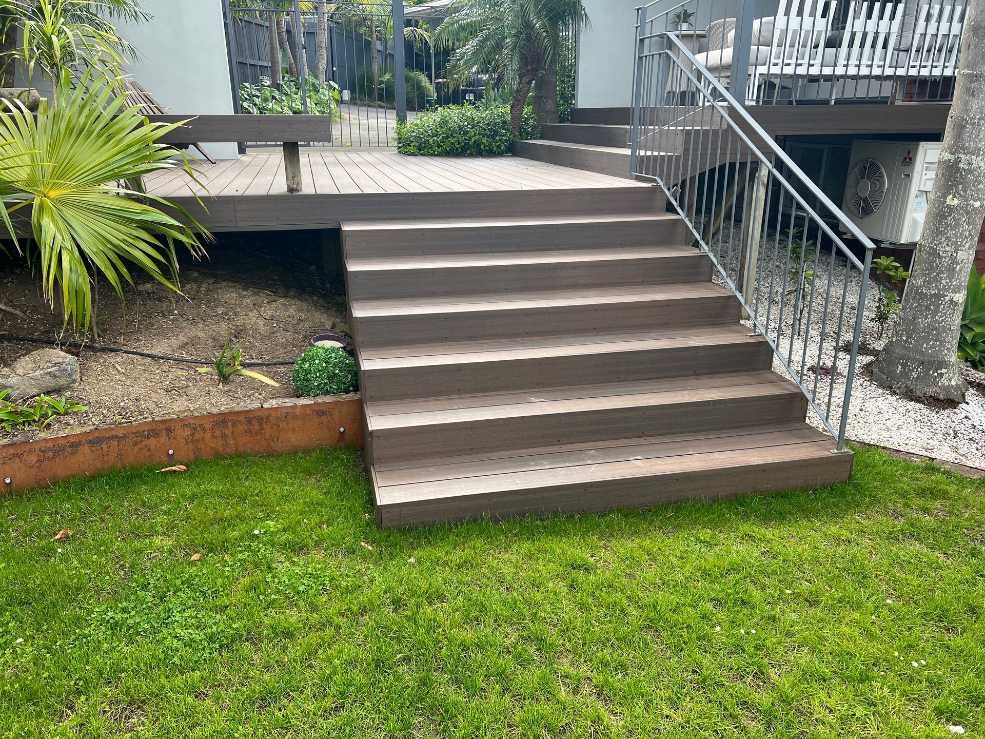 A set of wooden stairs leading up to a deck.