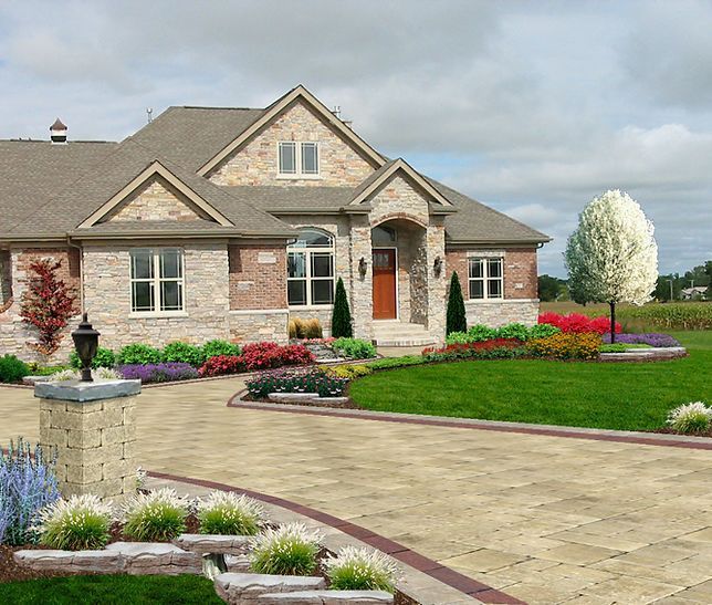 a large brick house with a driveway leading to it