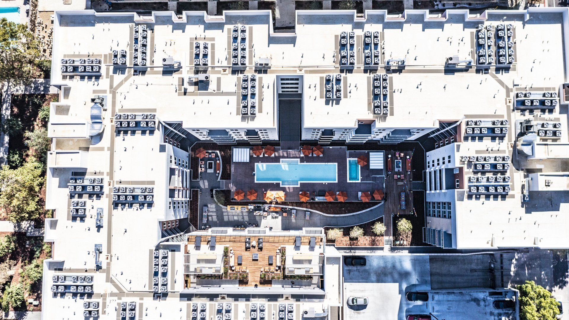 An aerial view of a building with a pool in the middle at Capitol Towers.