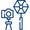 A blue camera icon on a tripod next to a hexagonal studio light.