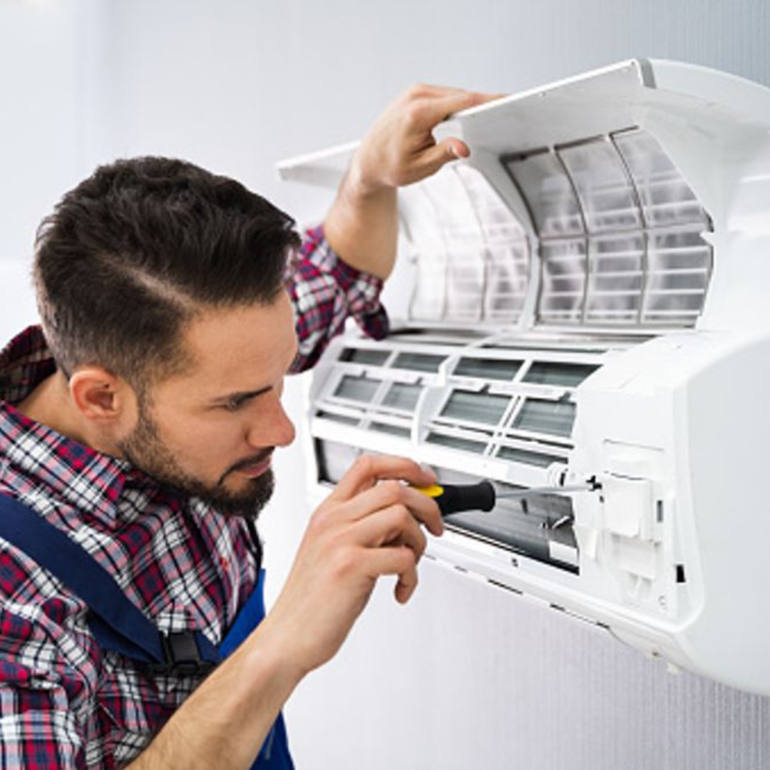 Michigan Air Care - fixing an air conditioner with a screwdriver .