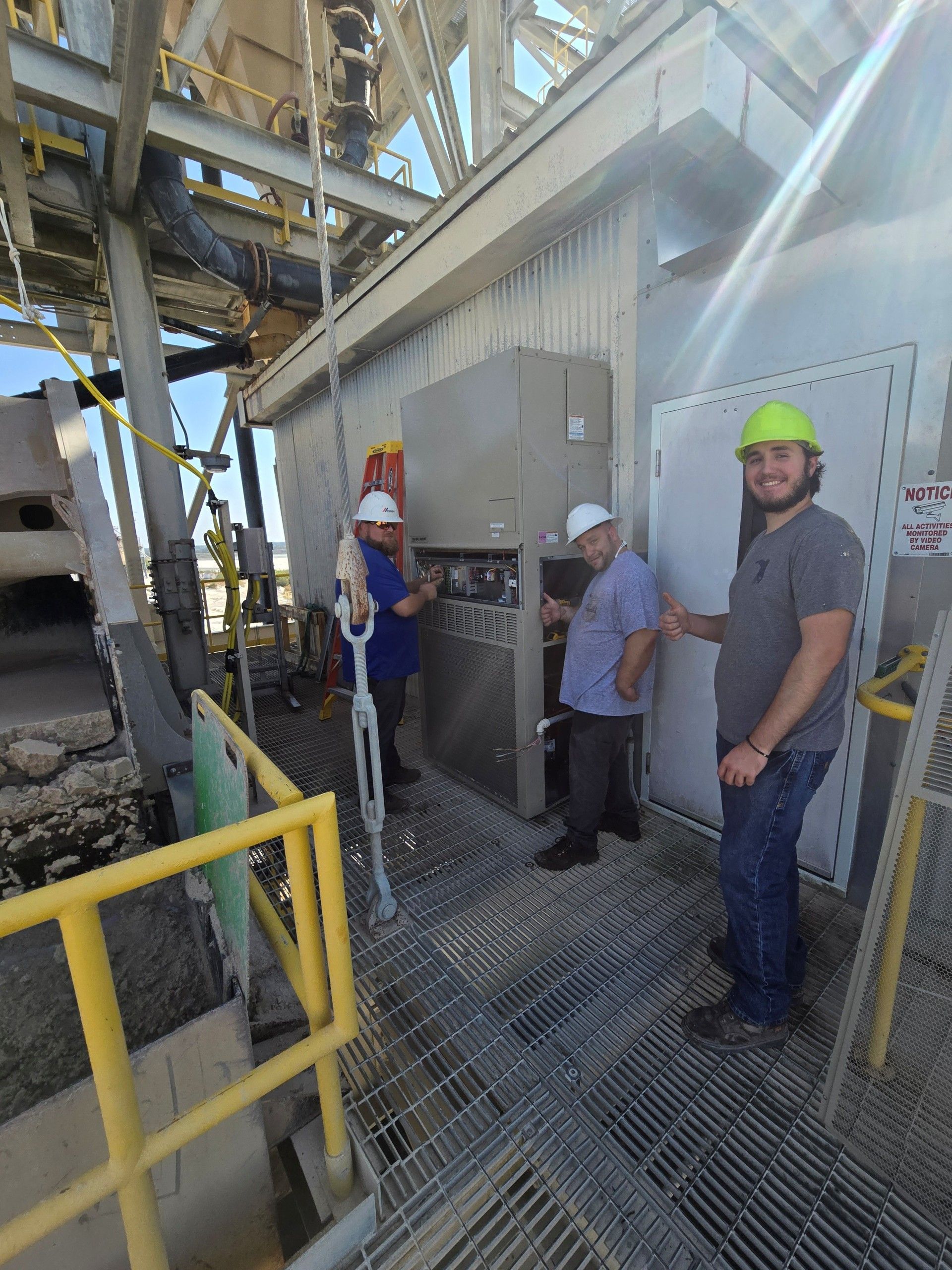 A person’s hand removing a mesh filter from the open front panel of a wall-mounted air conditioner. A person’s hand removing a mesh filter from the open front panel of a wall-mounted air conditioner.