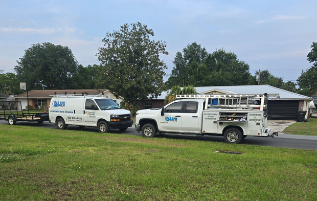 Low-angle view of industrial HVAC ductwork, metal pipes, and supporting beams in an unfinished building interior. Low-angle view of industrial HVAC ductwork, metal pipes, and supporting beams in an unfinished building interior.