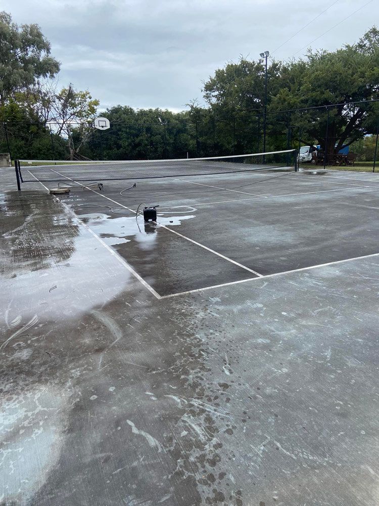 Cleaning The Outdoor Sports Court Using High Pressure Washer — High Pressure Cleaning Service In Tamworth, NSW