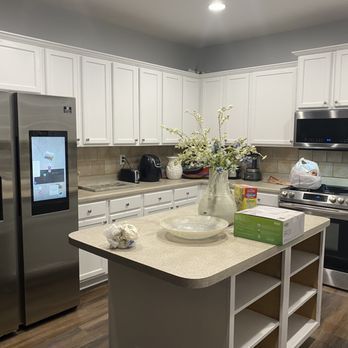 Kitchen with white cabinets, stainless steel appliances, and a center island.
