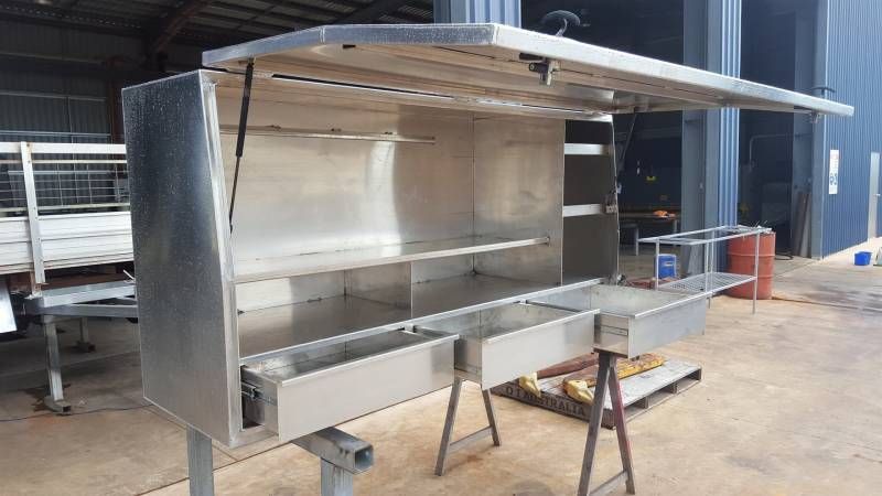 A Large Stainless Steel Cabinet is Sitting on Top of a Wooden Table — Roll Press NT In Tivendale, NT