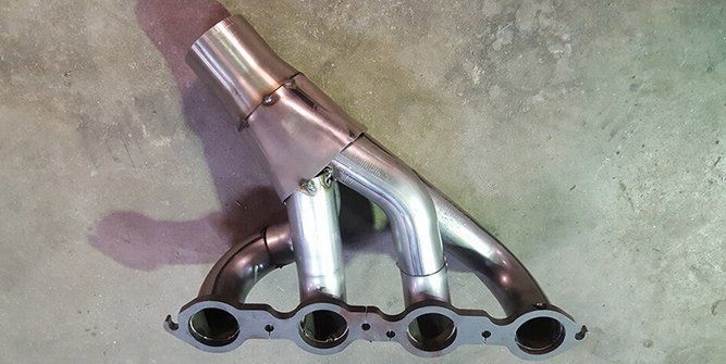 A Close Up of a Exhaust Pipe on a Concrete Surface — Roll Press NT In Tivendale, NT