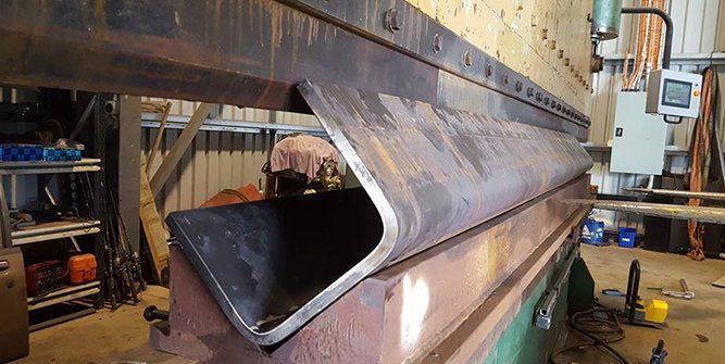 A Large Piece of Metal is Sitting on Top of a Machine — Roll Press NT In Tivendale, NT