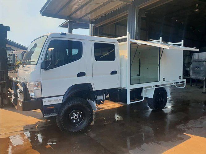 A White Truck is Parked in Front of a Building — Roll Press NT In Tivendale, NT