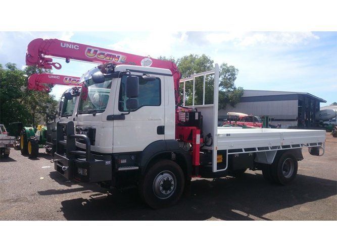 A White Truck With a Red Crane on the Back is Parked in a Parking Lot — Roll Press NT In Tivendale, NT