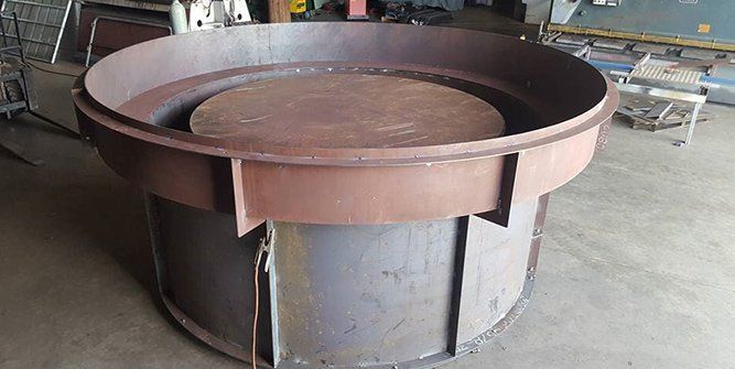 A Large Round Metal Object is Sitting in a Garage — Roll Press NT In Tivendale, NT