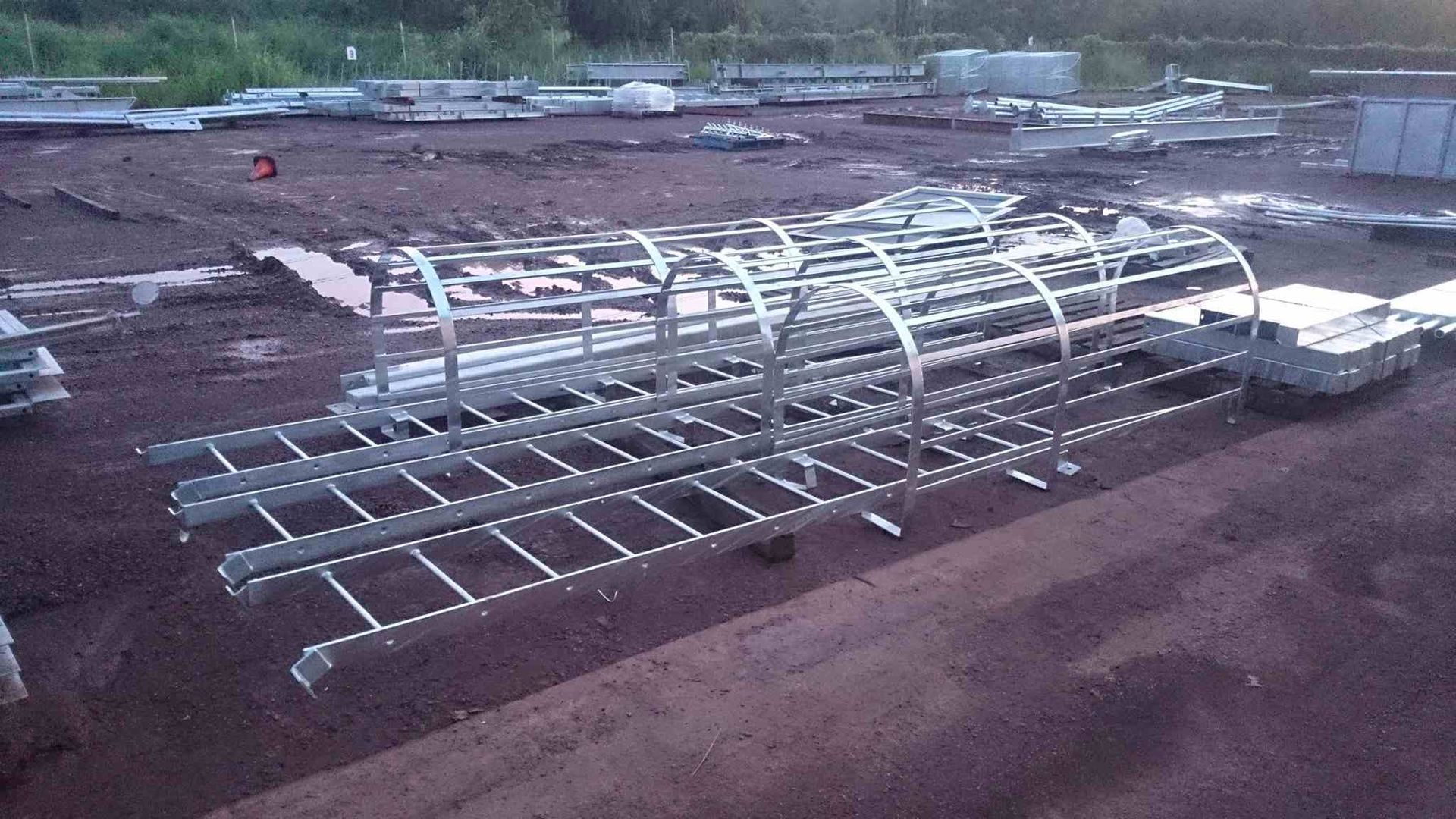 A Bunch of Metal Ladders Are Sitting on Top of a Dirt Field — Roll Press NT In Katherine, NT