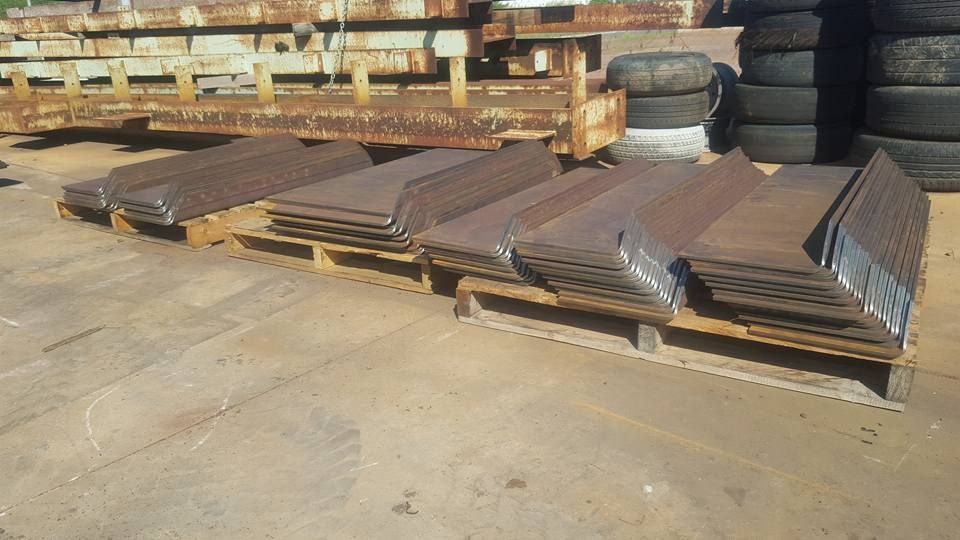 A Stack of Metal Sheets Sitting on Top of a Wooden Pallet — Roll Press NT In Palmerston, NT