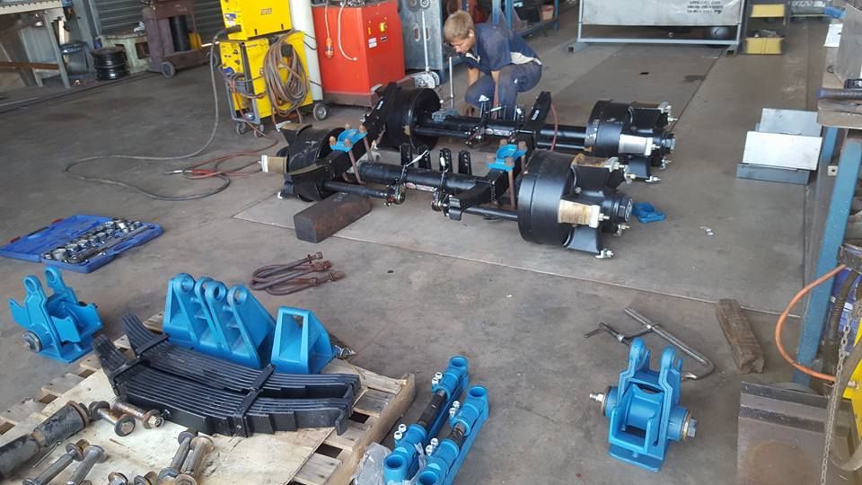 A Man is Working on a Piece of Equipment in a Garage — Roll Press NT In Alice Springs, NT