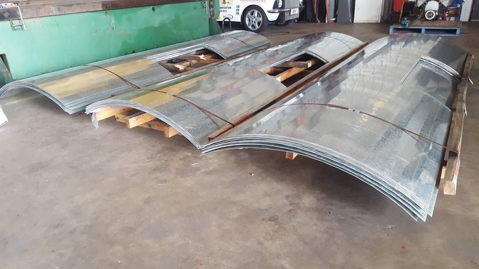 A Bunch of Metal Sheets Are Stacked on Top of Each Other on a Pallet — Roll Press NT In Kununurra, WA
