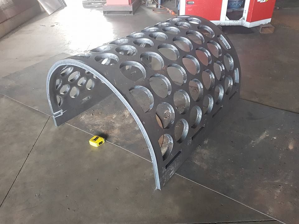 A Piece of Metal With Holes in It is Sitting on the Floor Next to a Tape Measure — Roll Press NT In Tivendale, NT