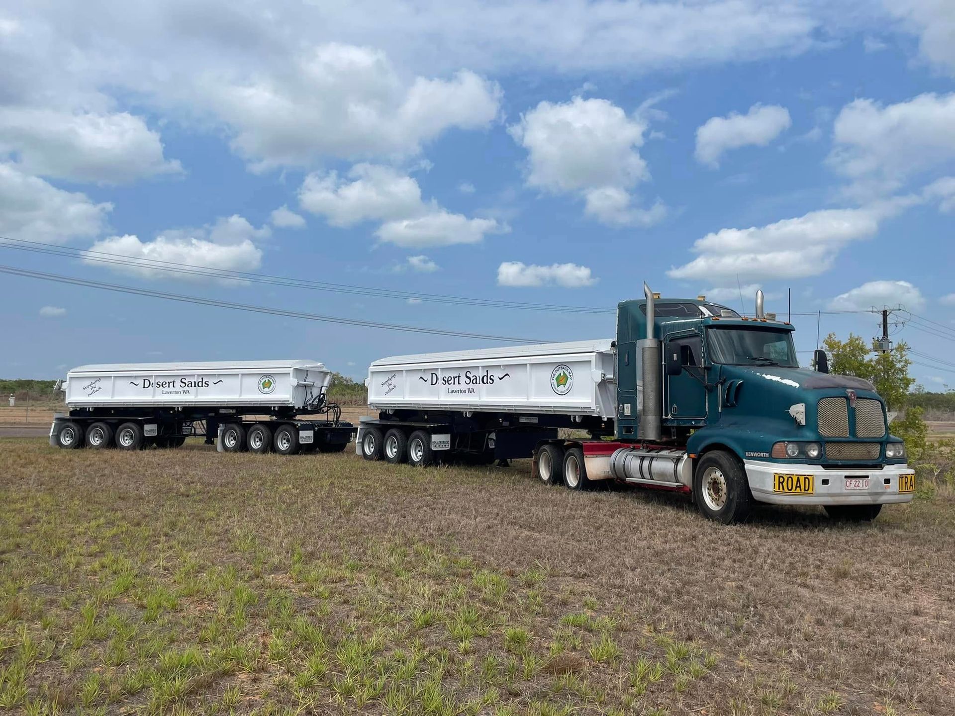 A Semi Truck With a Trailer Attached to It is Parked in a Field — Roll Press NT In Berrimah, NT