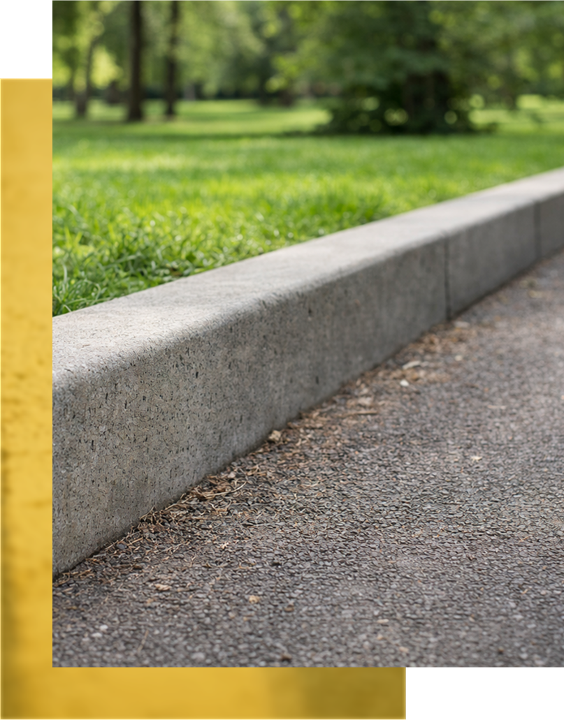 Outdoor dining area with wooden table, woven chairs, and gray patio tiles.