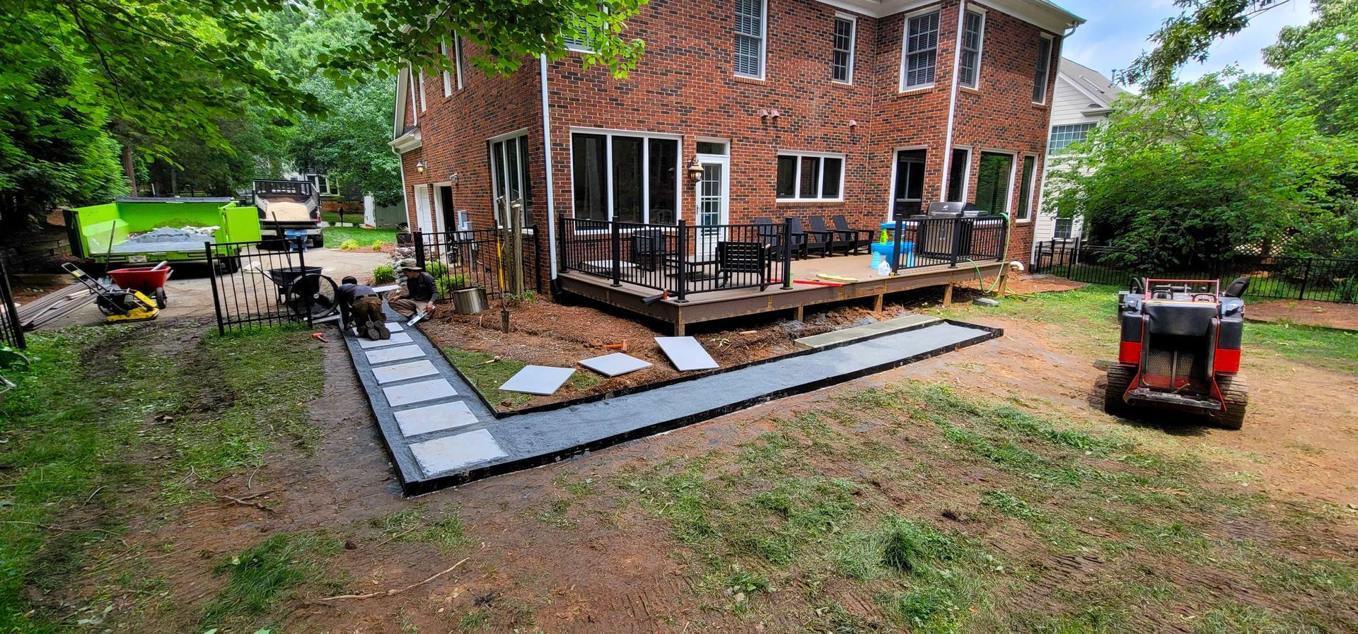 A custom walkway installation in Charlotte, NC - Haven Landscape Design hard at work