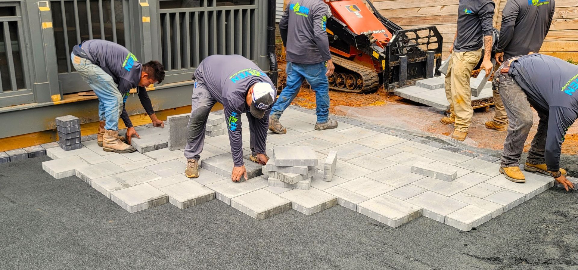 A home in Charlotte, NC getting a stone patio installation - Haven Landscape Design hard at work.