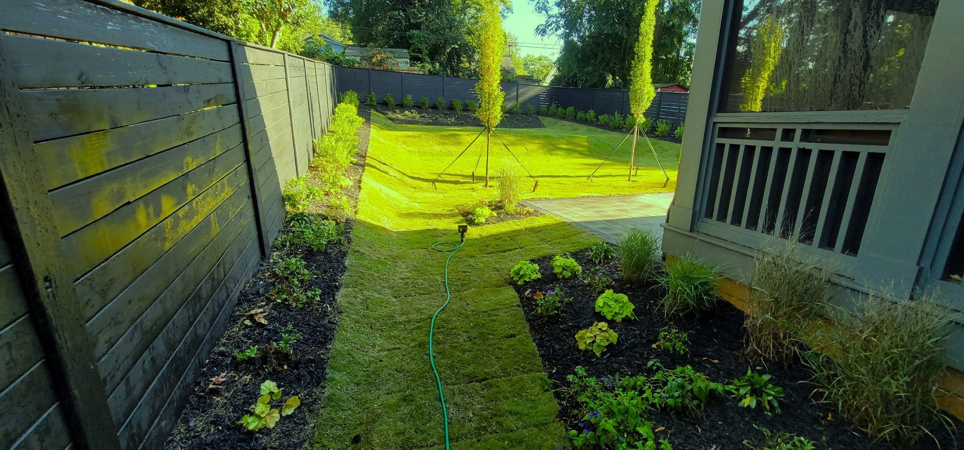 An after picture of a home in Charlotte, NC with a finished origami landscape installation by Haven Landscape Design.