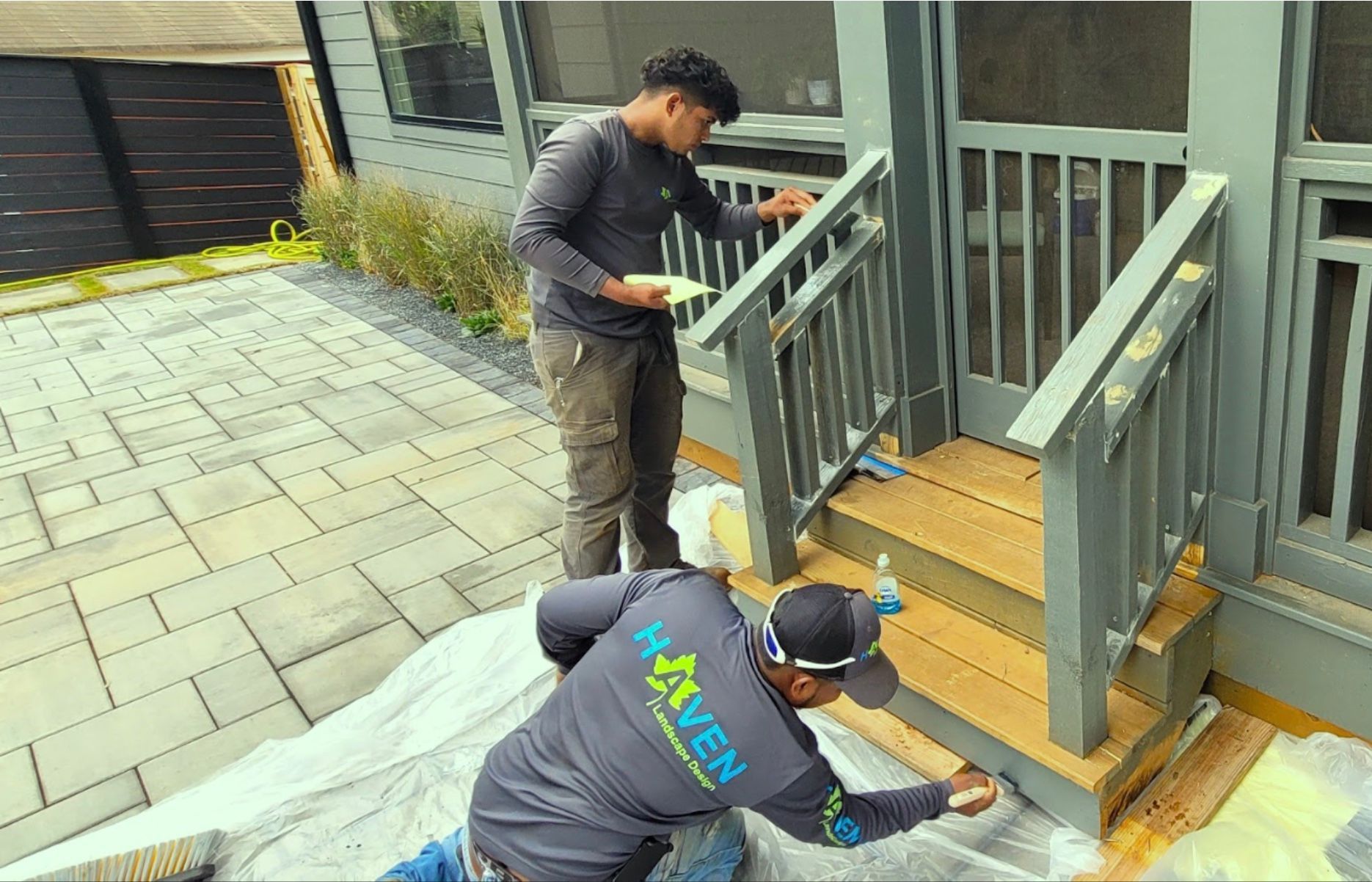 A brick house with a deck and a walkway leading to it.