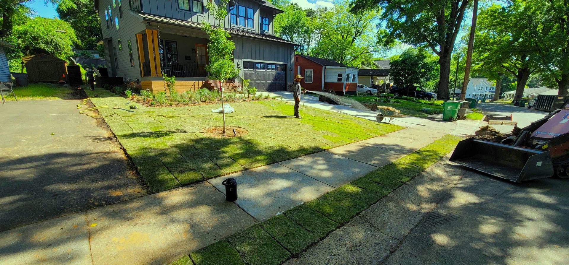A home in Charlotte, NC getting their newly installed sod watered - Haven Landscape Design hard at work.