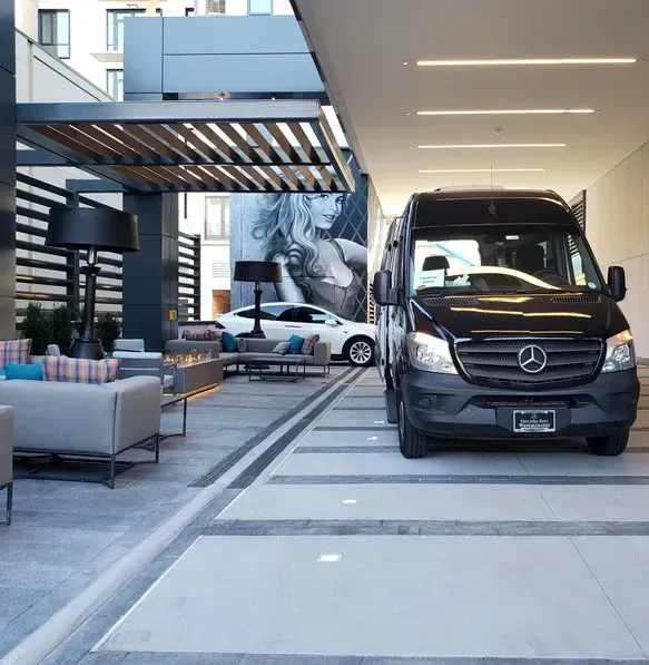 A black mercedes van is parked in a parking lot