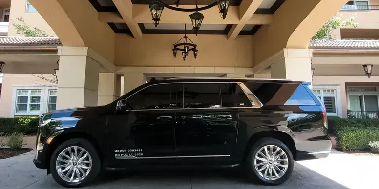 A black suv is parked in front of a building