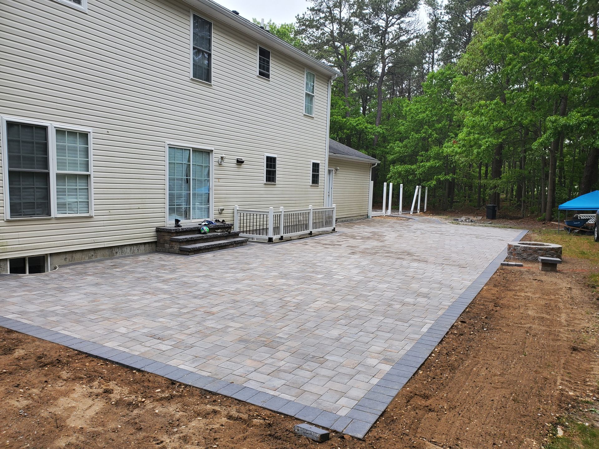 A large white house with a patio in front of it.