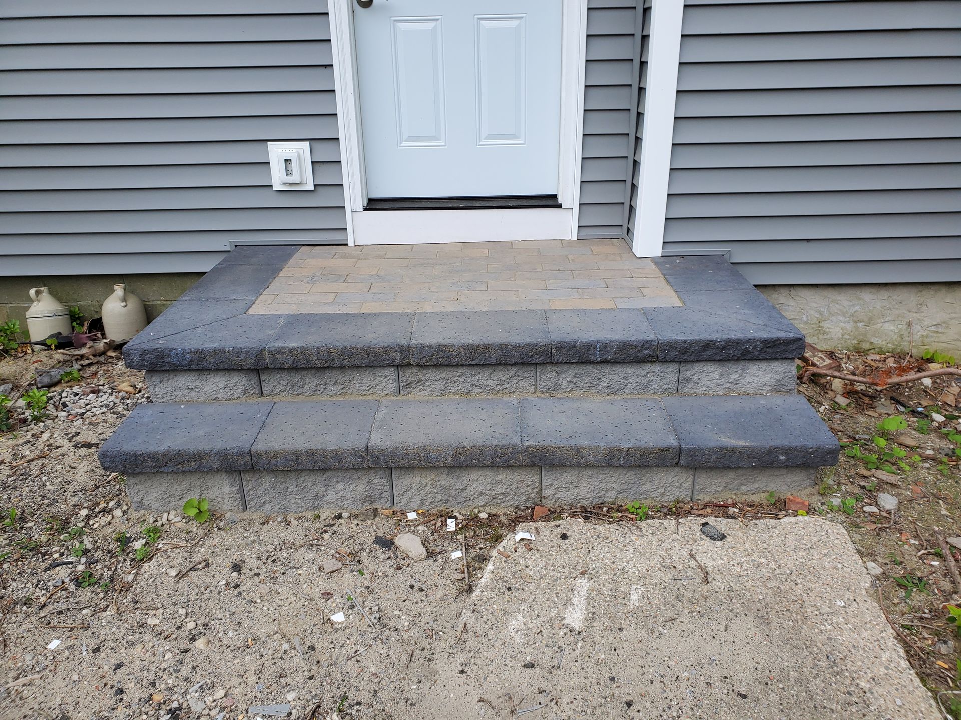 A set of steps leading up to the front door of a house.