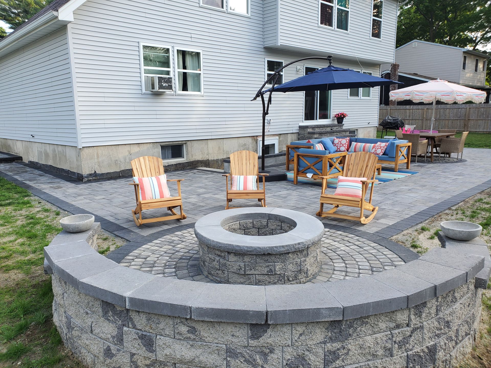 There is a fire pit in the middle of the patio.