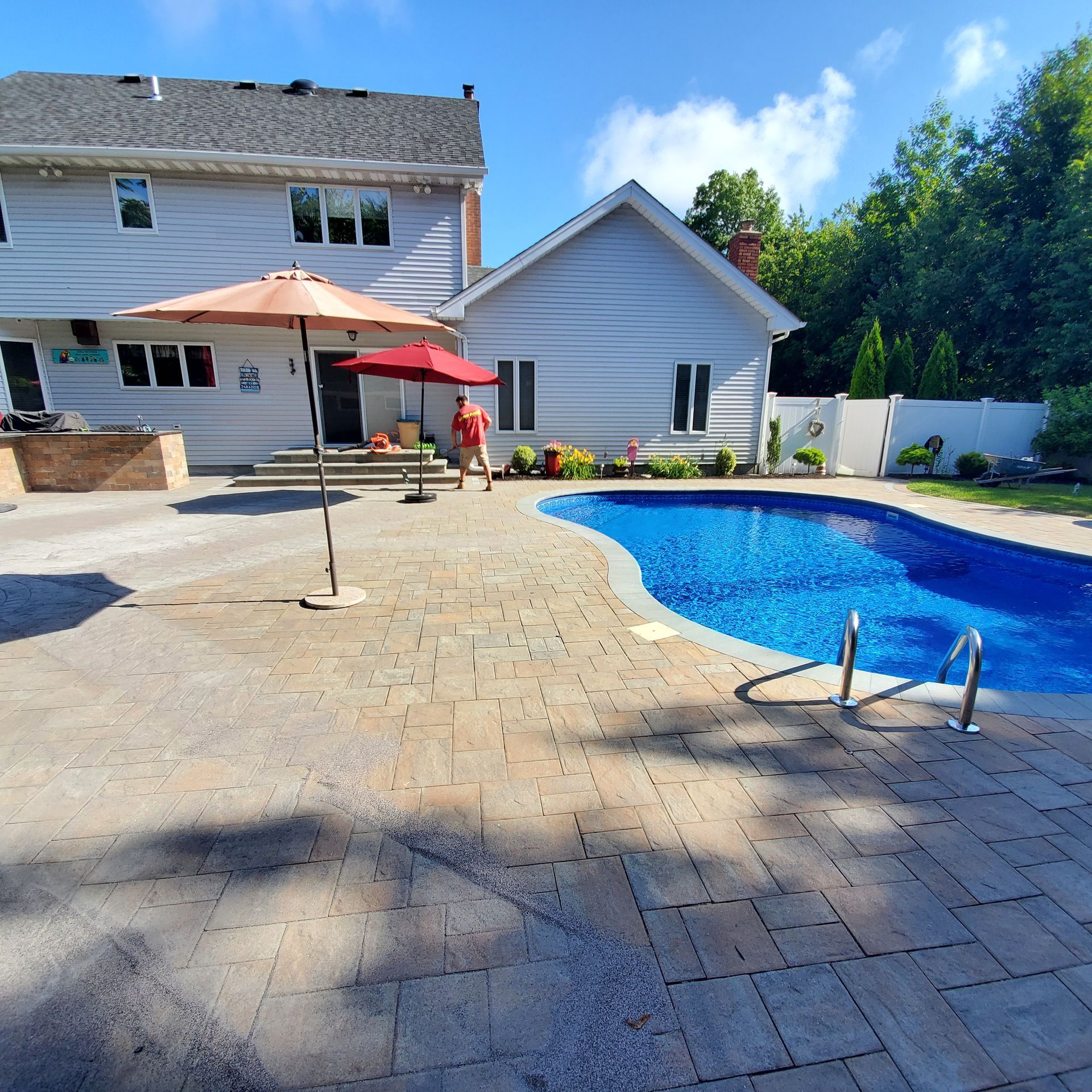A large swimming pool in front of a house