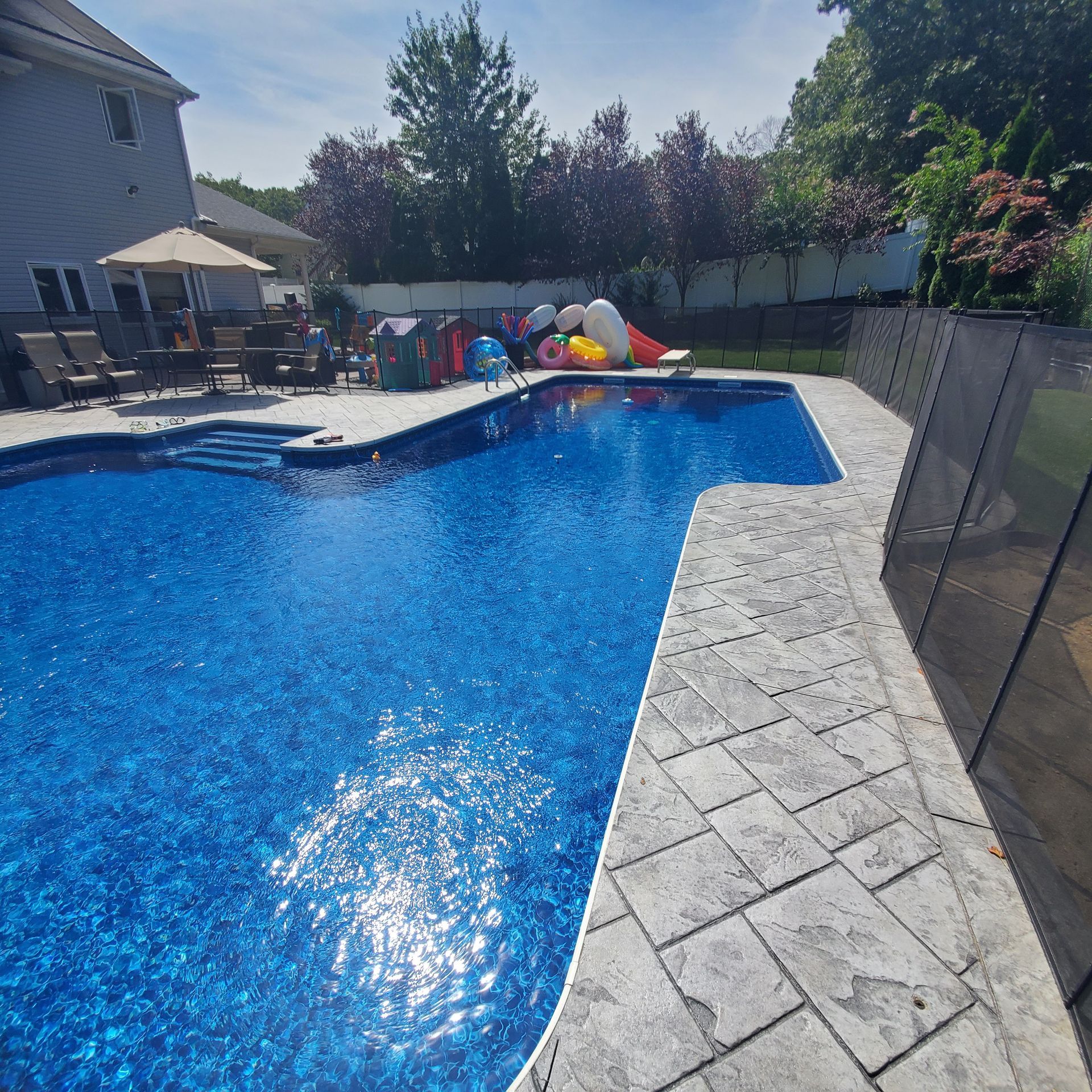 A large swimming pool with a fence around it